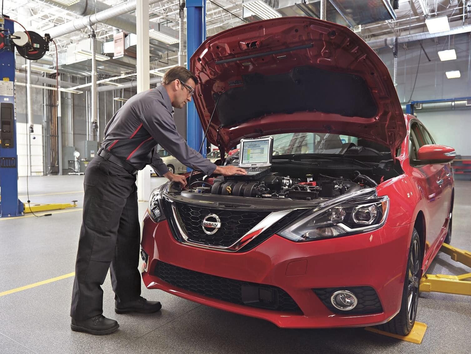 Technician analyzing Car Issue with Technology
