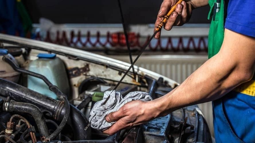 Technician servicing car