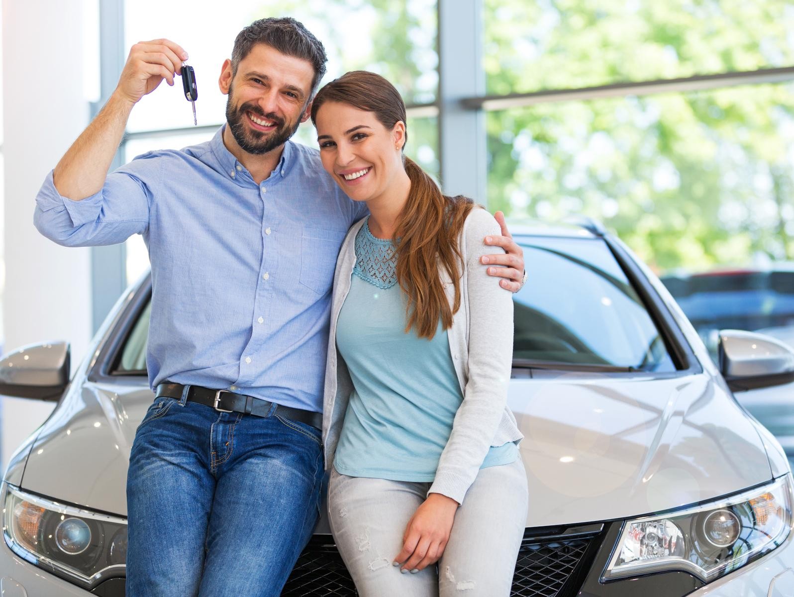 Happy Couple in front of subscription car