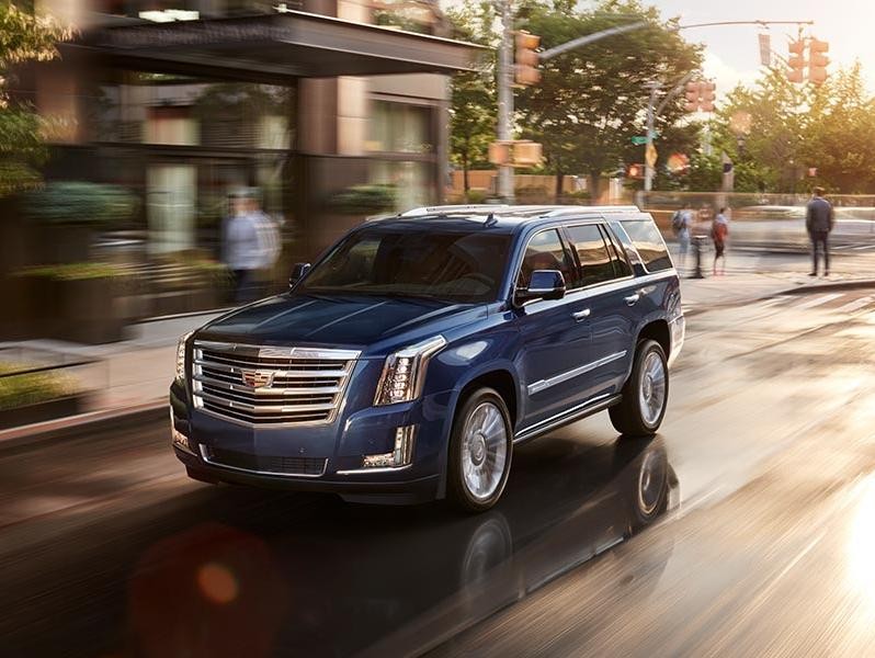2018 Cadillac Escalade driving down the road.