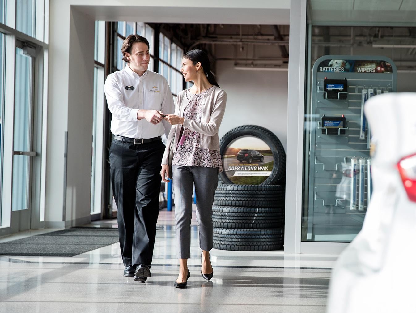 Chevrolet Certified Service Employee handing keys to women.