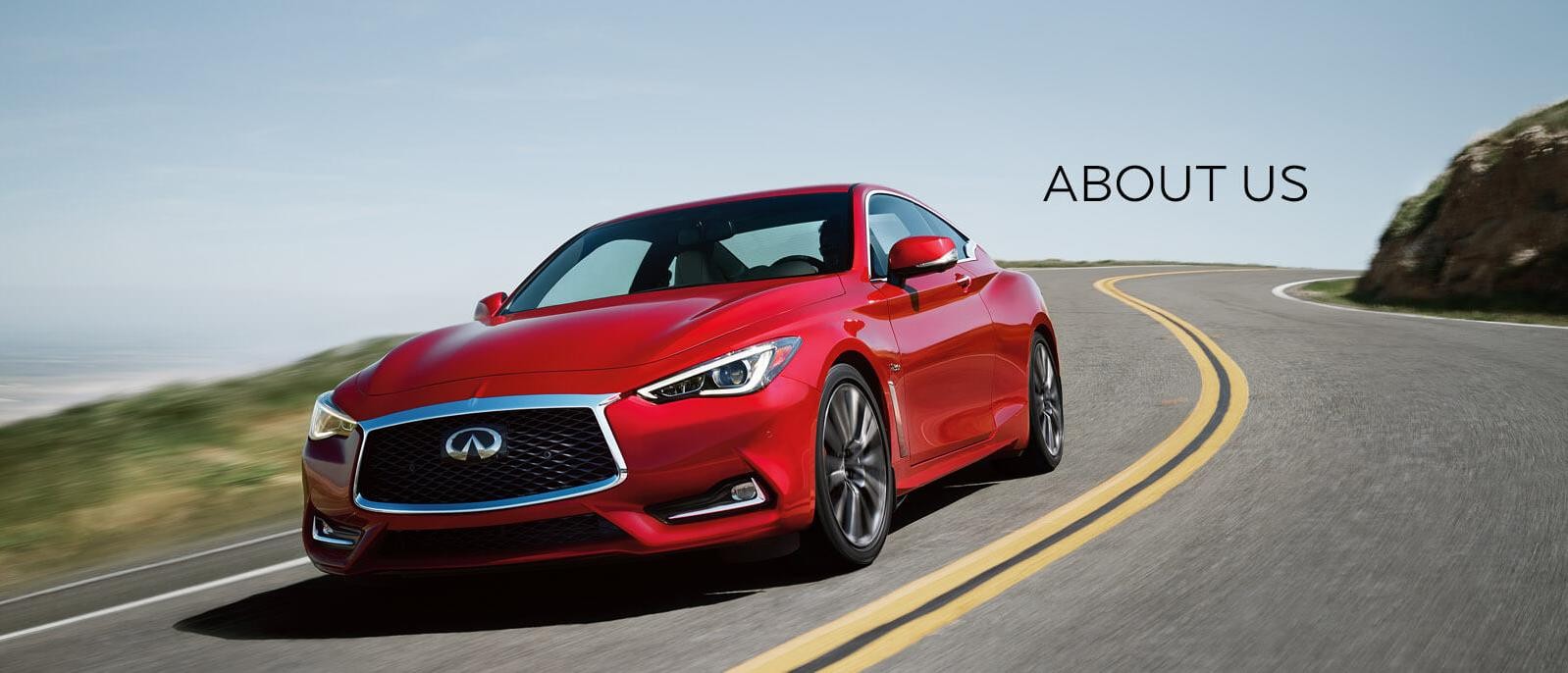 Infiniti Q60 driving down a curvy hill.