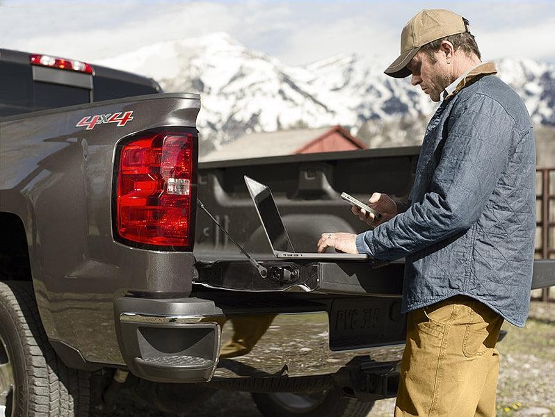 Man working on laptop on tailgate