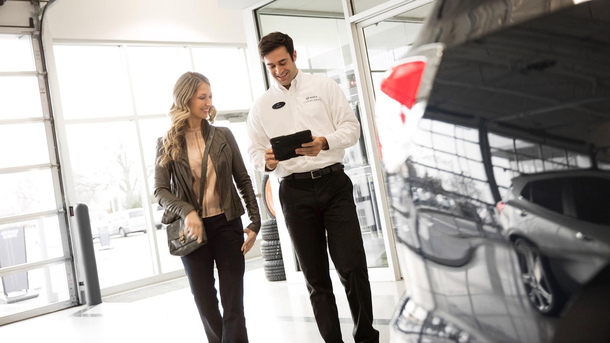 Buick Tech with iPad talking to a woman