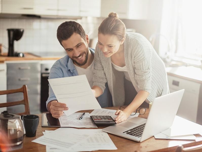 Couple checking on their financing at home.