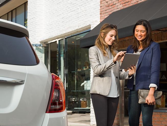  Women Checking Car Value On iPad