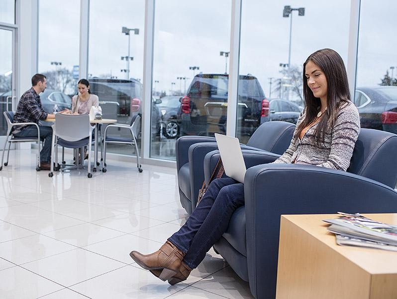 Woman in dealership on laptop