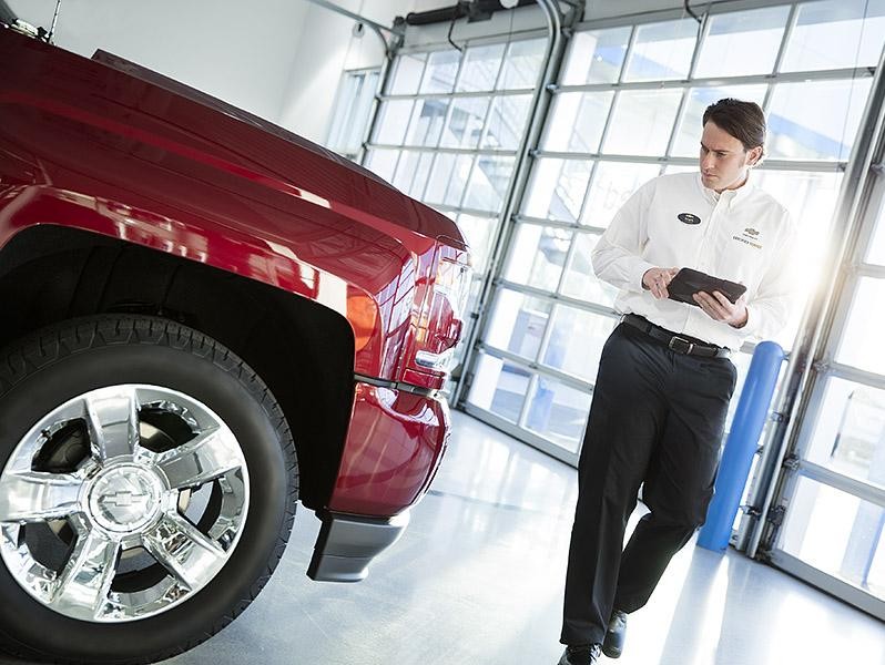 Service technician inspecting vehicle