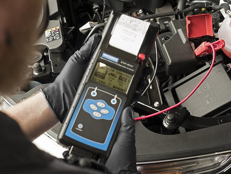 Service technician doing diagnosis on a vehicle.