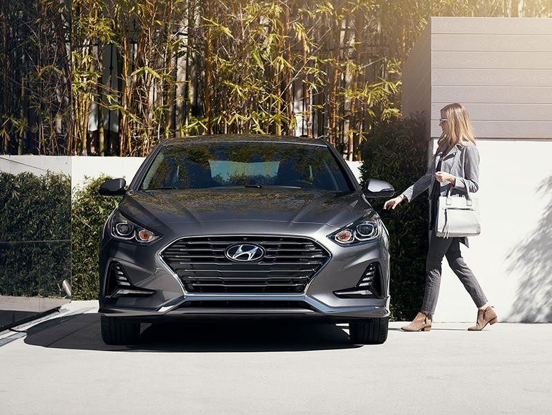 2018 Hyundai Sonata front view with driver getting into her car.