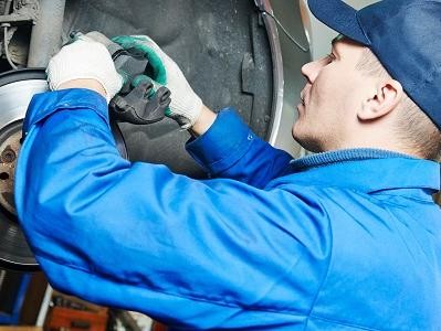 Service Technician Inspecting Vehicle Brake Pads