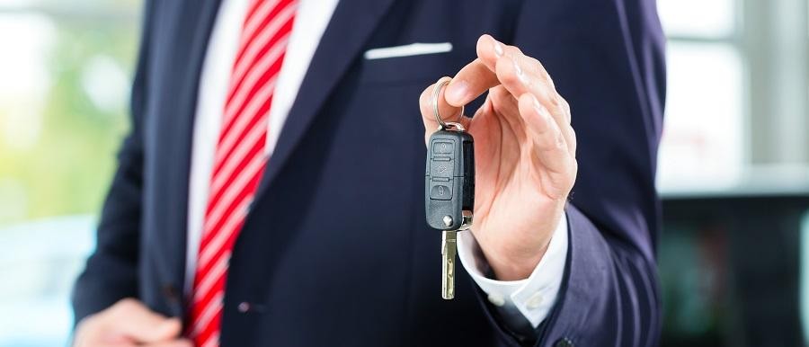 Used SUV Salesman Handing Over Keys