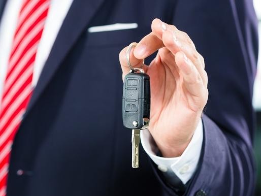 Used SUV Salesman Handing Over Keys